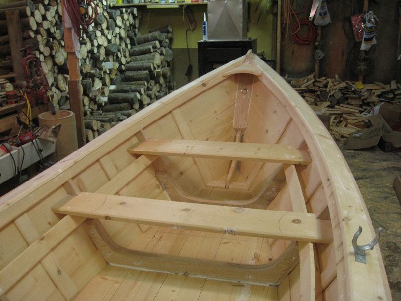 Side view of a Grand Banks dory showing the narrow flat bottom and flared hull shape