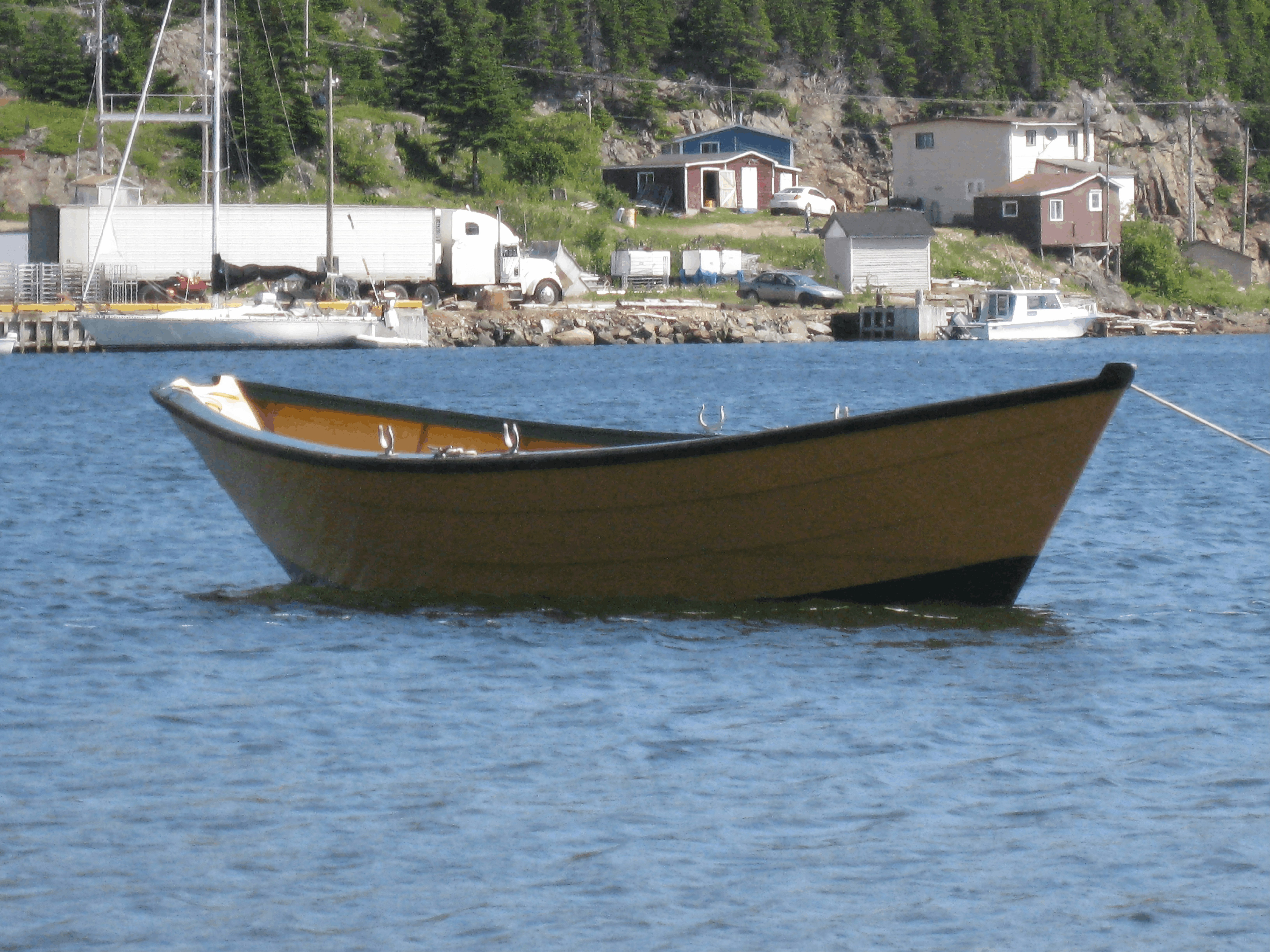 A finished 16-foot Grand Banks dory on the water